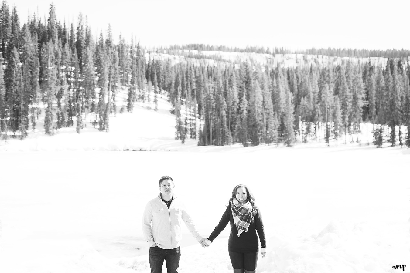 engaged couple by snowy lake on the Grand Mesa