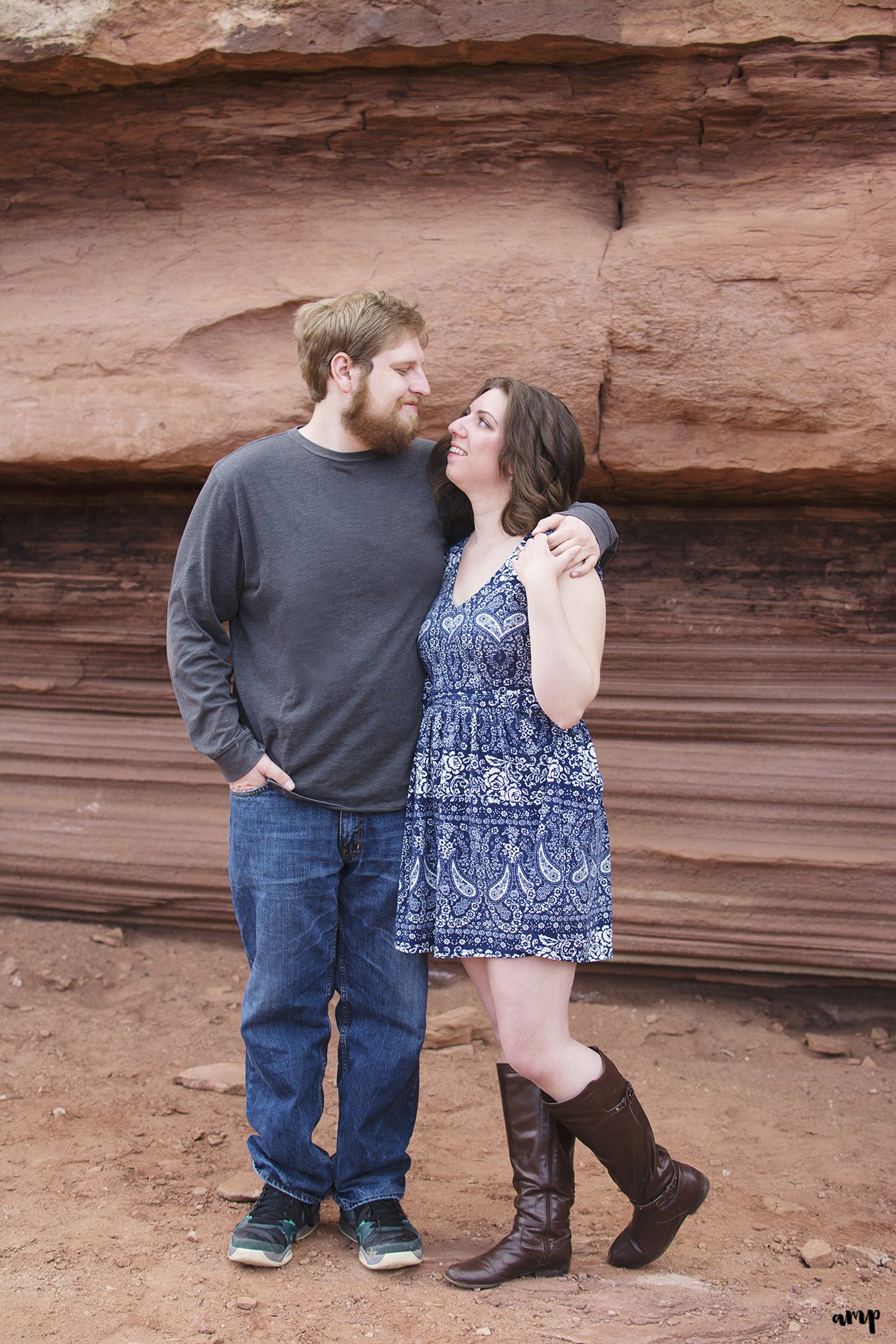 Engaged couple cuddling in the desert