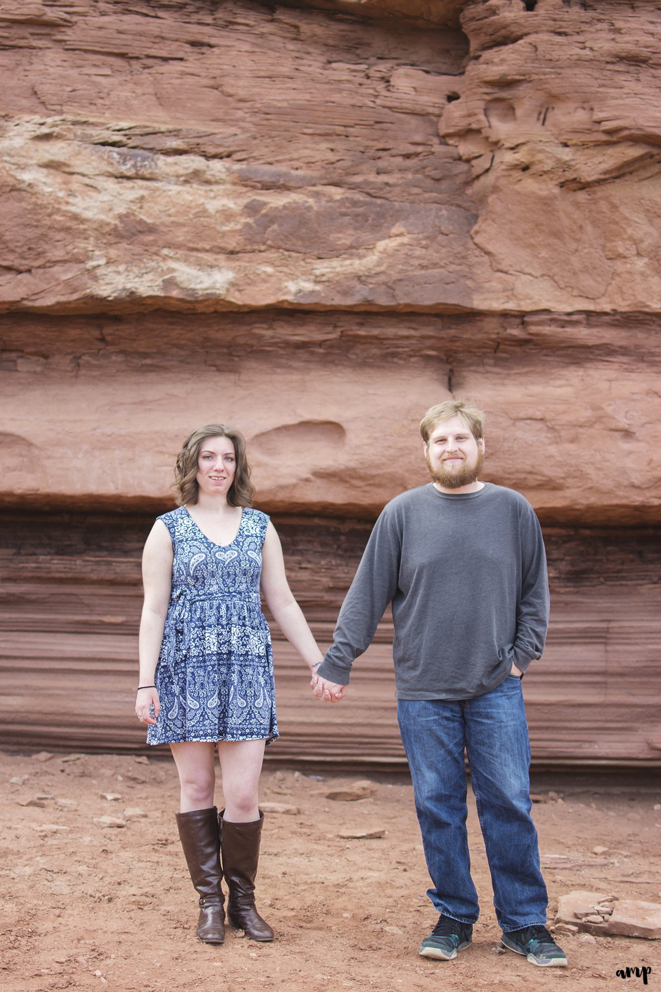 Engaged couple holding hands in the desert