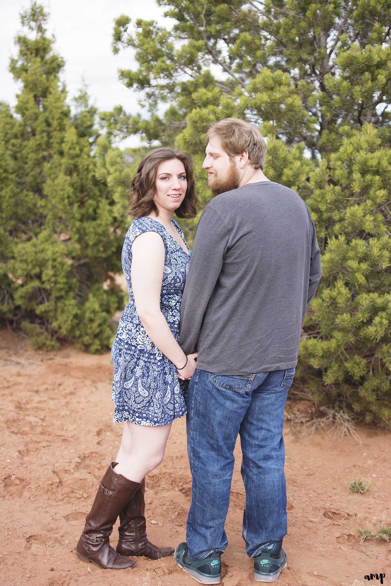 Engaged couple holding hands in the desert