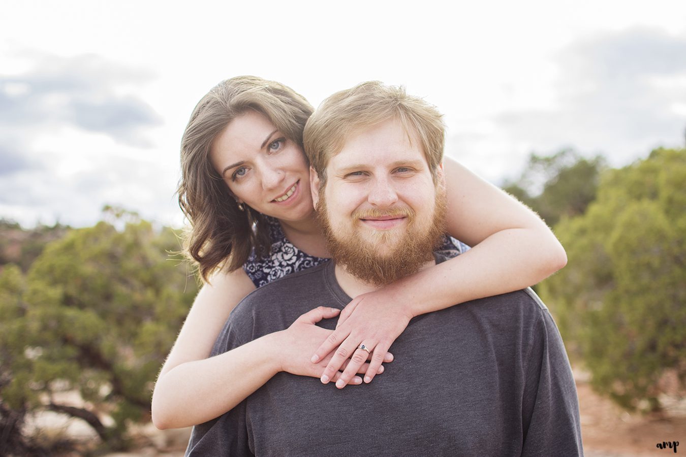 Engaged couple holding hands in the desert