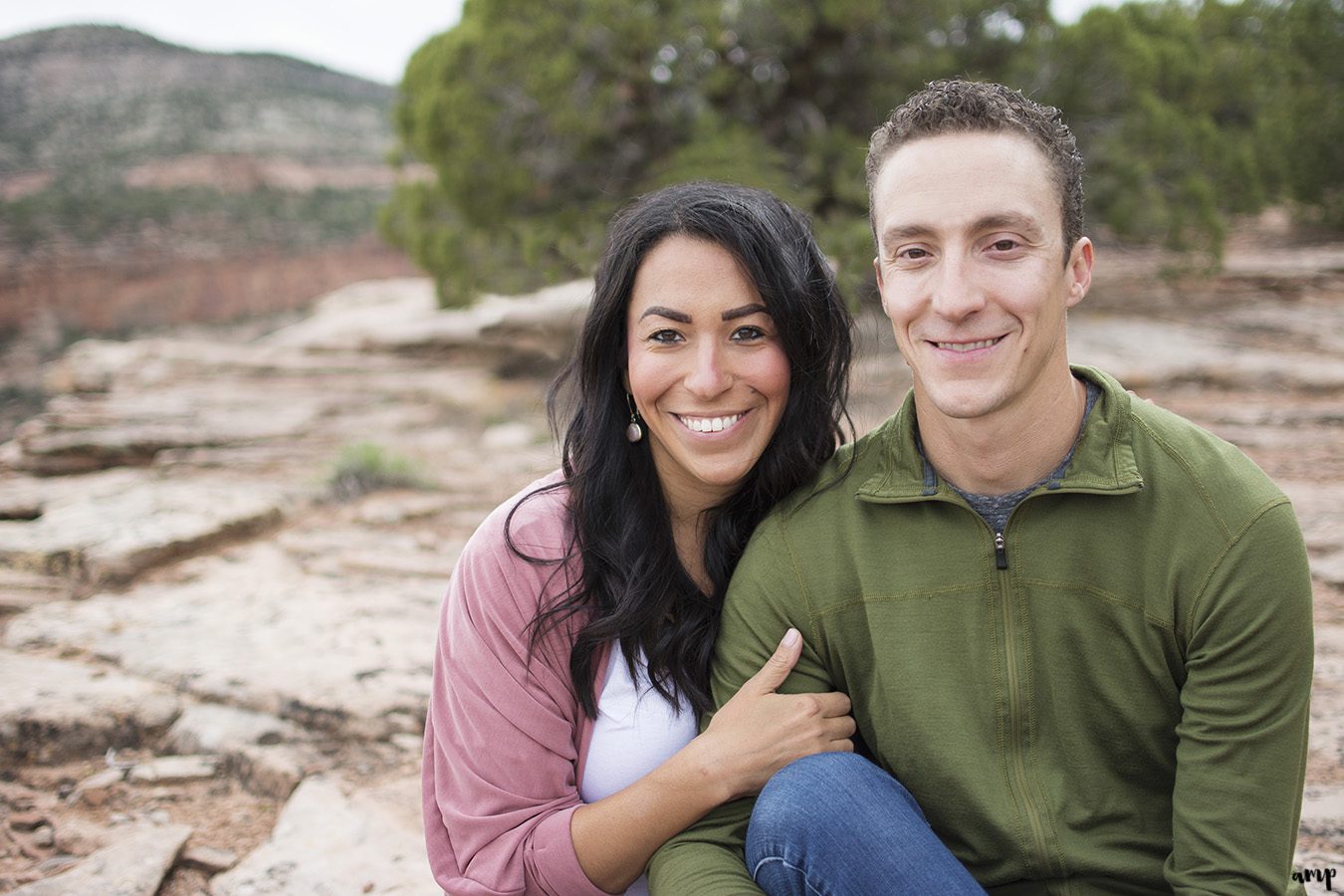 Couple sitting in the desert of the Colorado National Monument