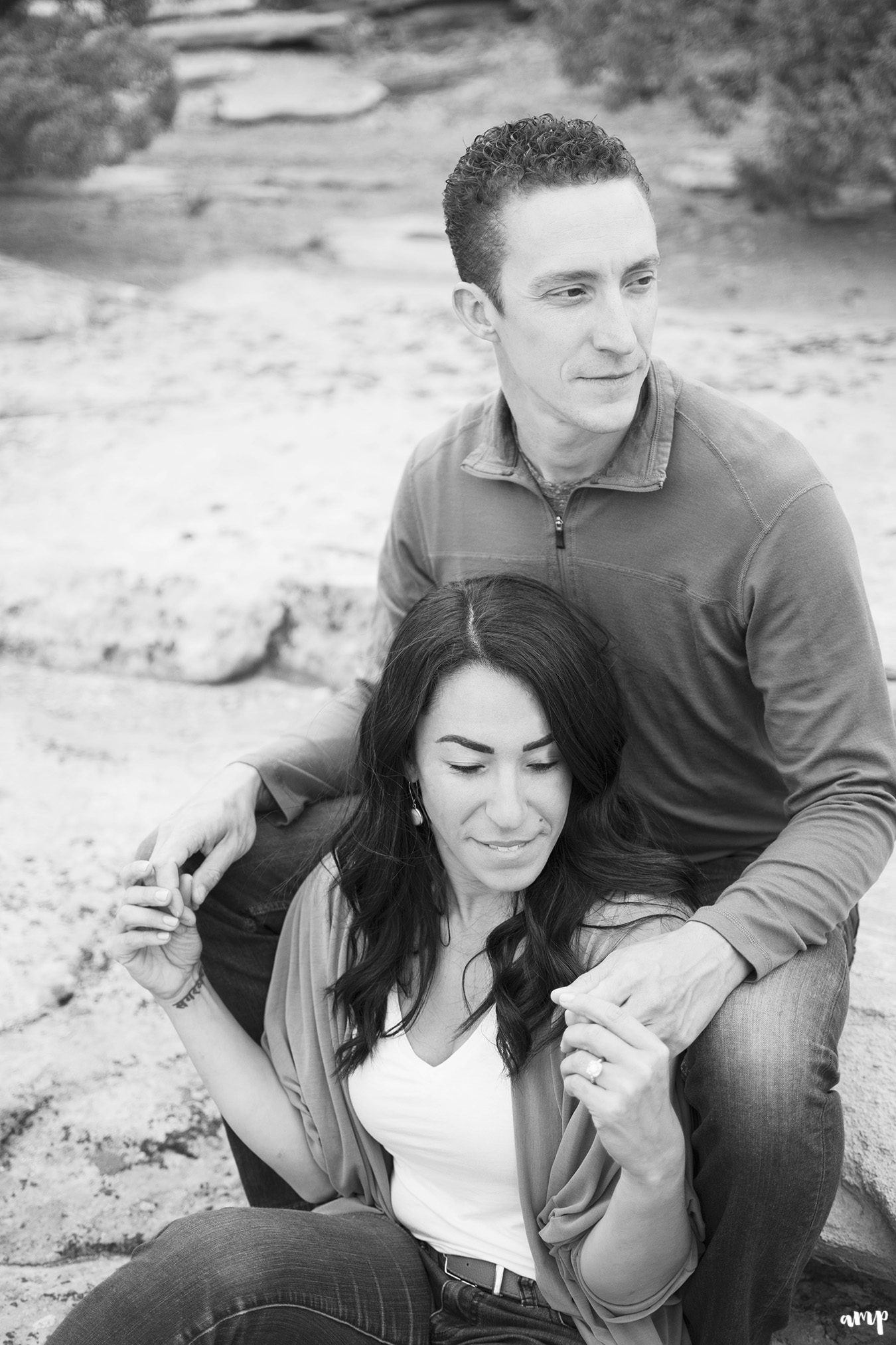 Couple sitting in the desert of the Colorado National Monument