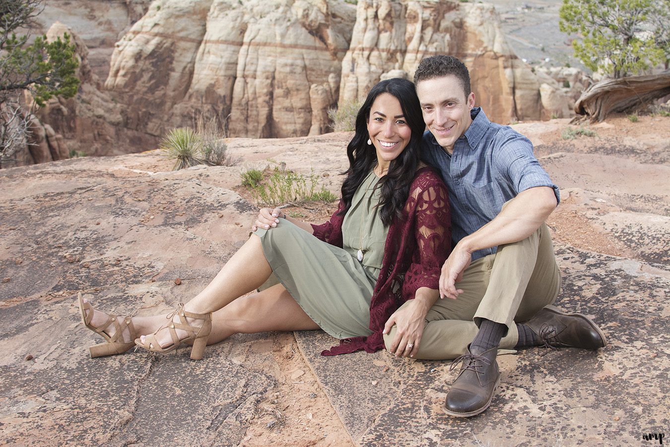 Couple sitting in the desert of the Colorado National Monument