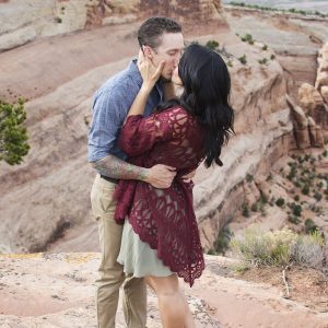 Couple kissing for their desert engagement photos