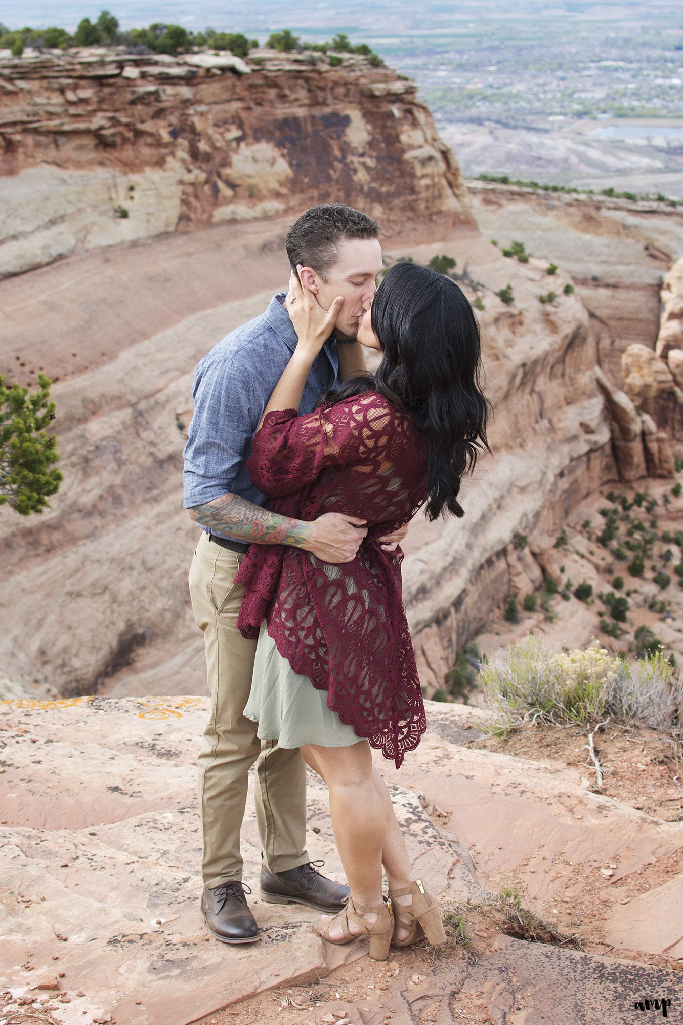 Couple kissing for their desert engagement photos