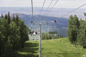 Bride and groom riding the ski lift at their destination wedding