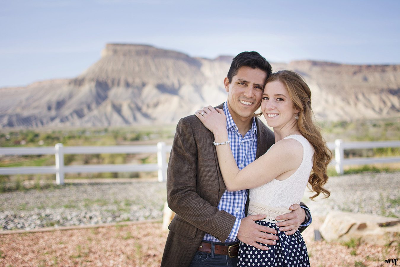 Couple entwined arm in arm with Mt. Garfield in the background