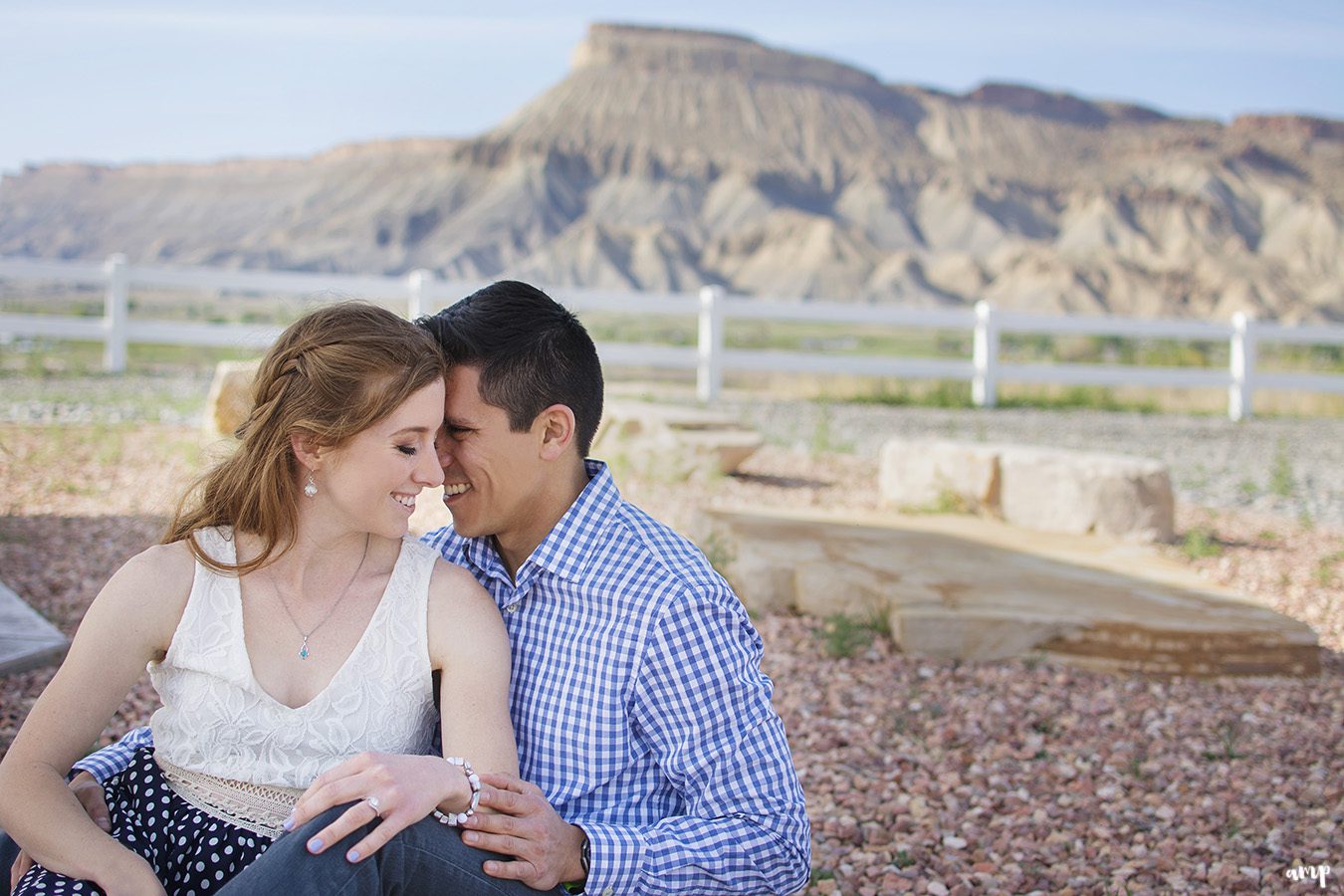 Couple cuddling with Mt. Garfield in the background