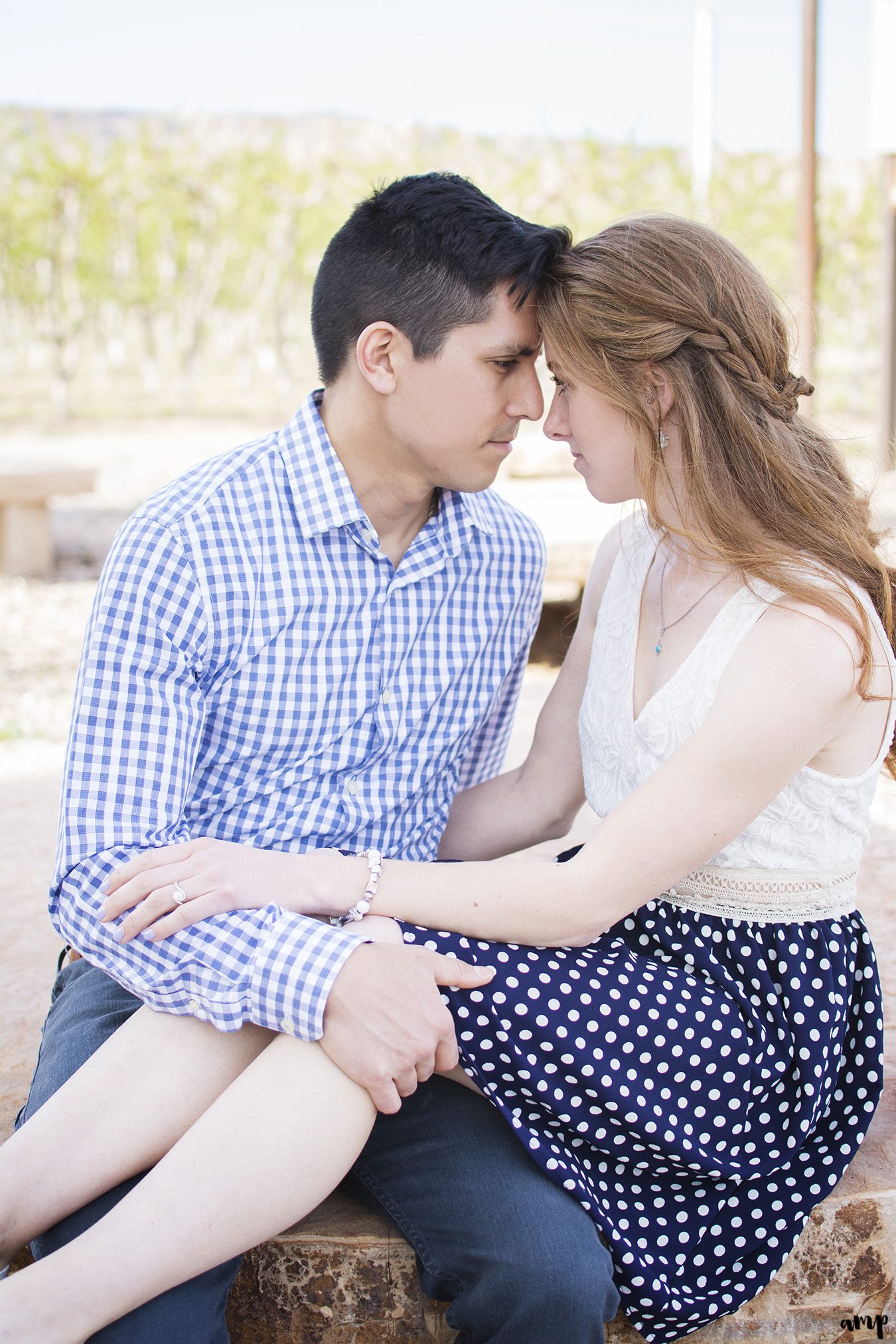 Engaged couple sitting with foreheads touching