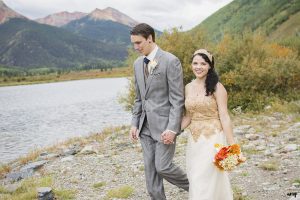 Bride and Groom walking by Crystal Lake near Red Mountain & Ouray, Colorado
