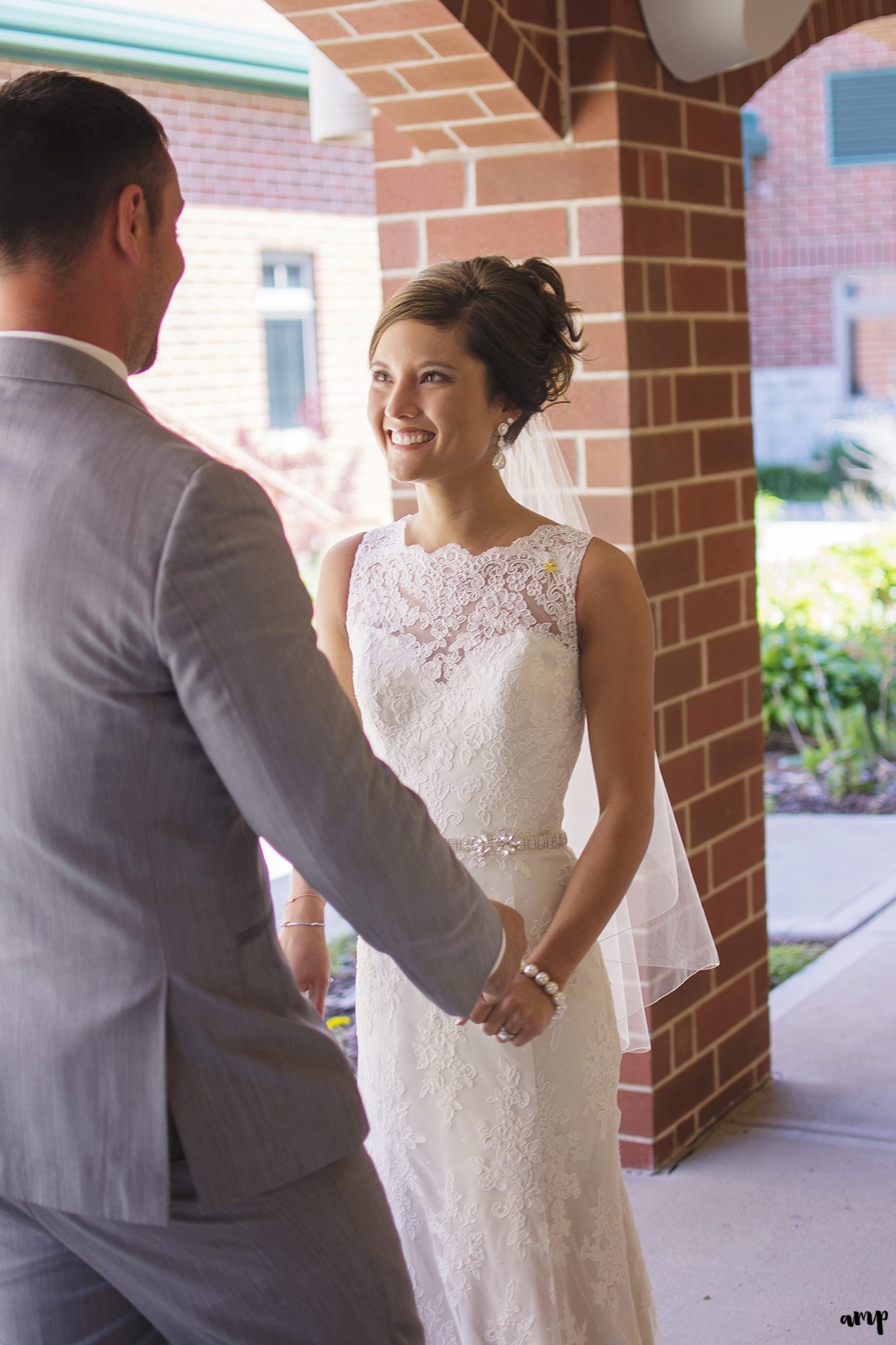 Bride & groom's first look in church courtyard