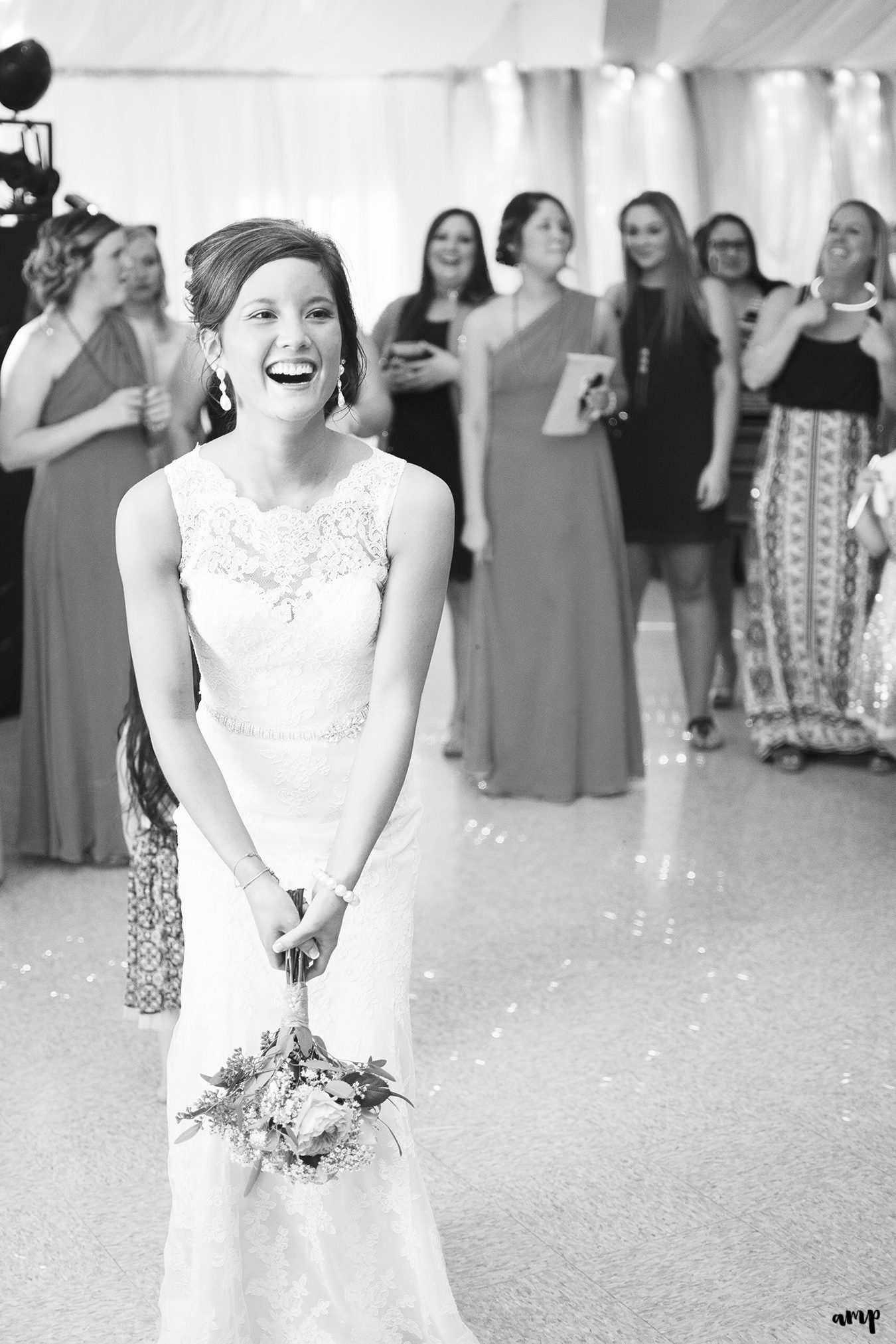 Bride laughing during wedding bouquet toss