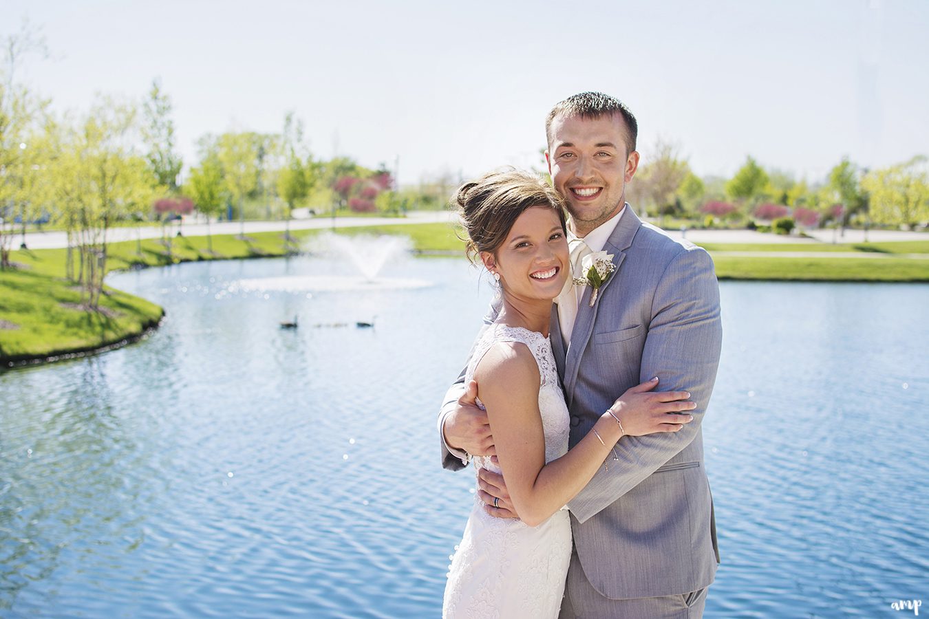 Bride & groom beside pond
