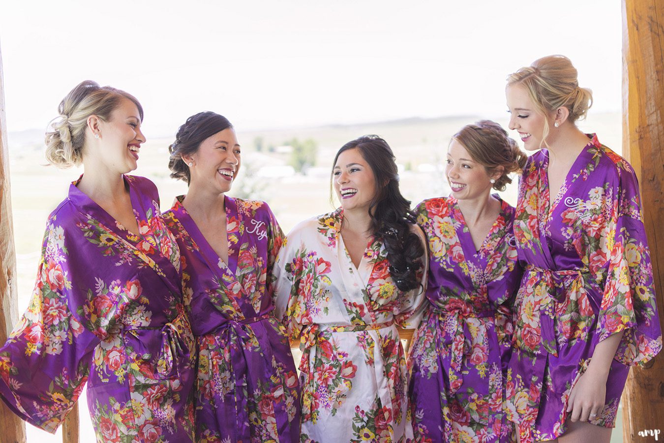 Bridesmaids in matching robes getting ready