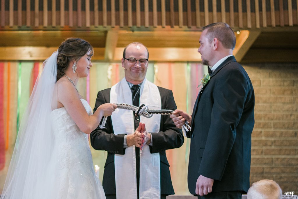 Bride and groom tie the knot in a handfasting ceremony