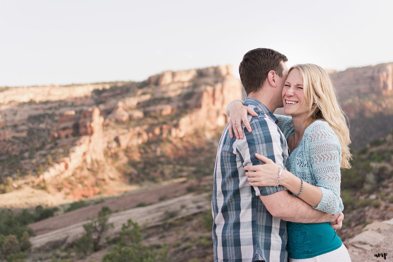 Couple laughing in the desert of the Colorado National Monument