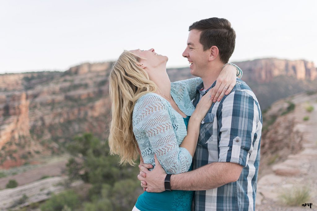 Couple laughing in the desert of the Colorado National Monument