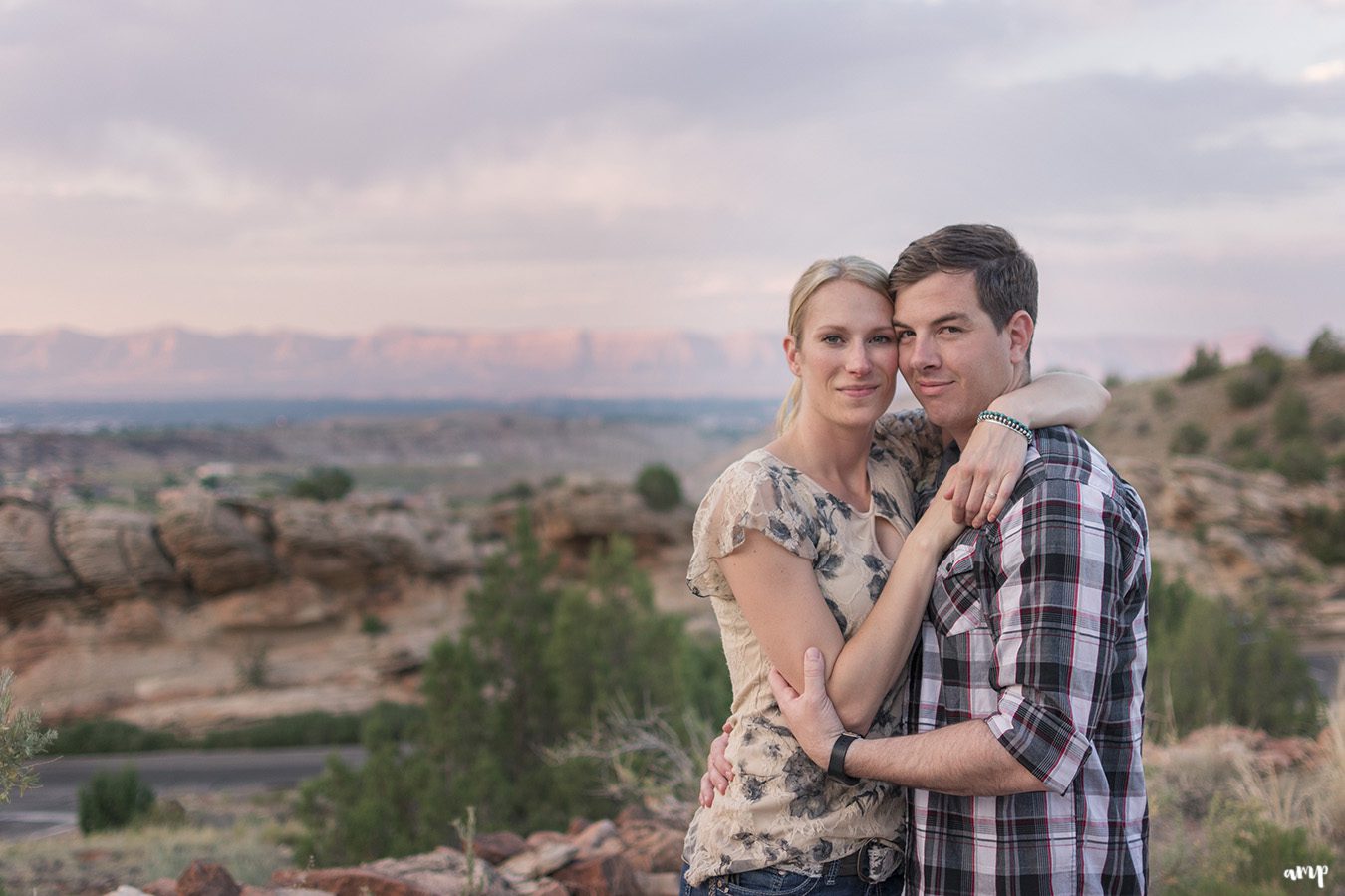 Couple cuddling in the desert of the Colorado National Monument