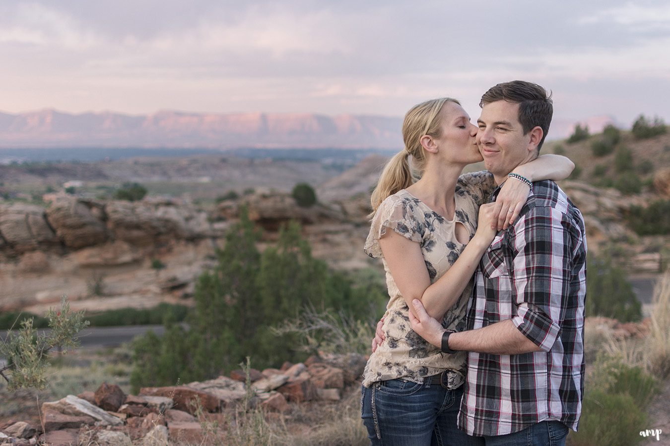 Couple kissing in the desert of the Colorado National Monument