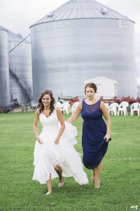 Bride and matron of honor walking to first look