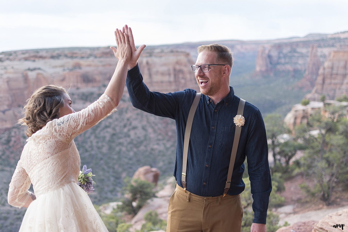 Bride and Groom high five after their elopement on the Colorado National Monument