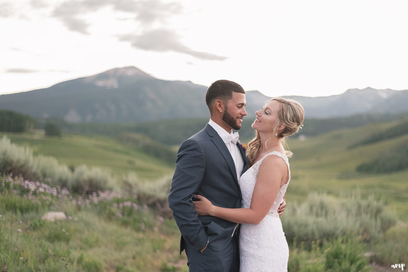 Bride and groom at sunset with mountains in the distance