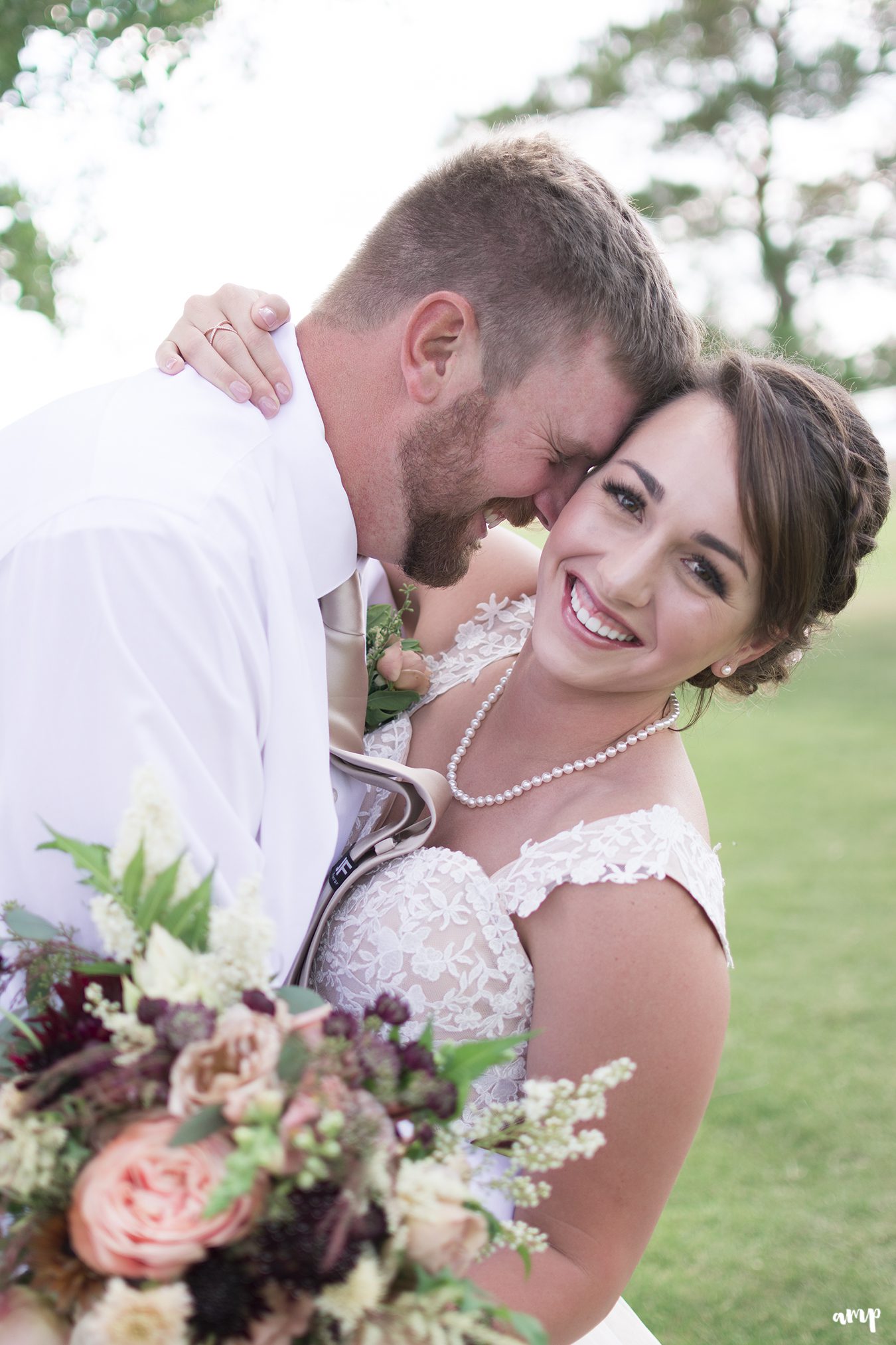 Whimsical vintage flower bouquet and bride with groom laughing