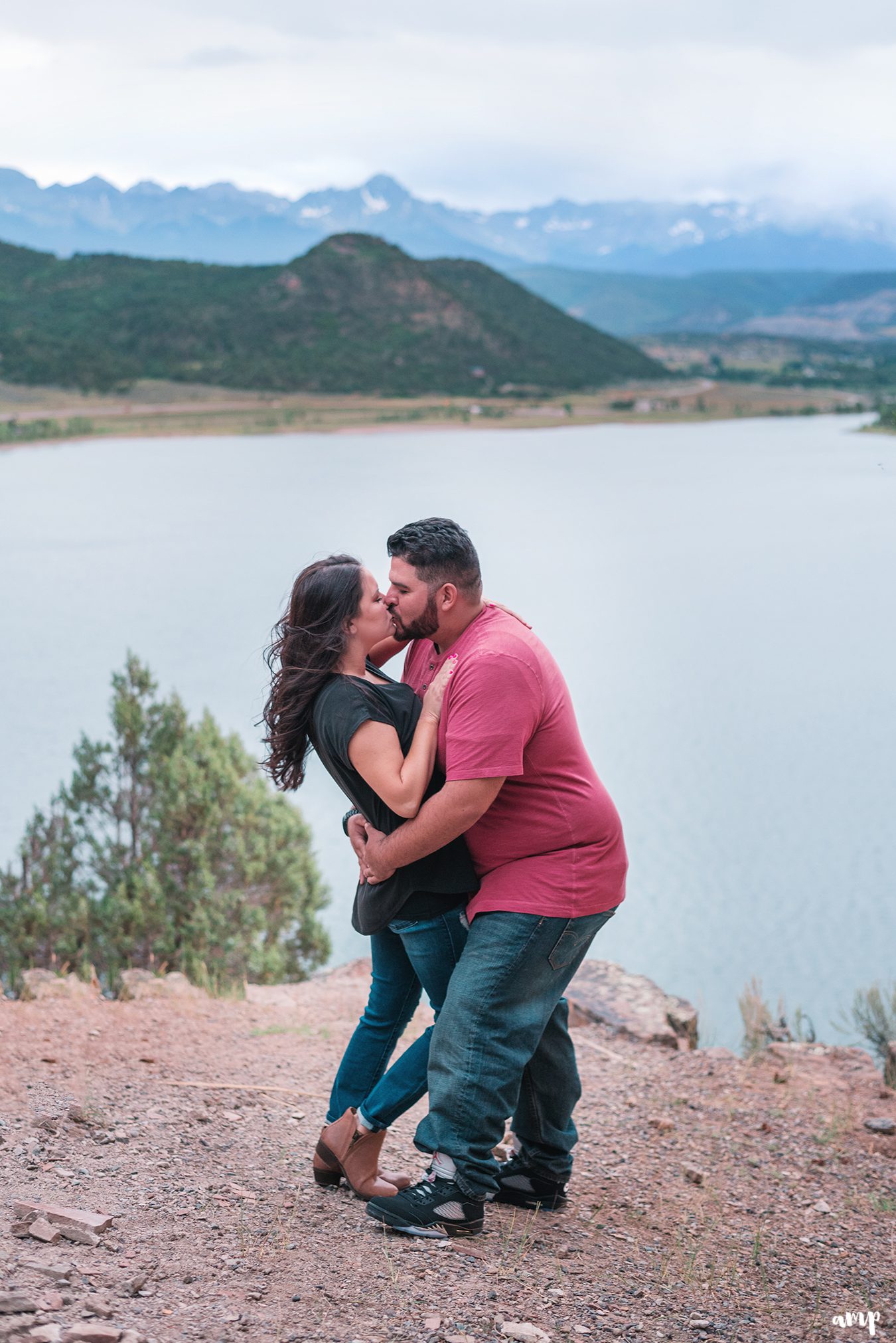 Engaged couple kissing overlooking the San Juan Mountains