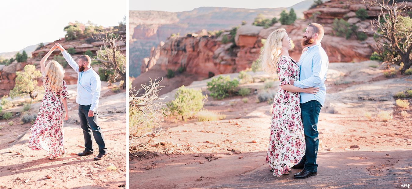 Soft glow of the desert as engaged couple dance at sunset
