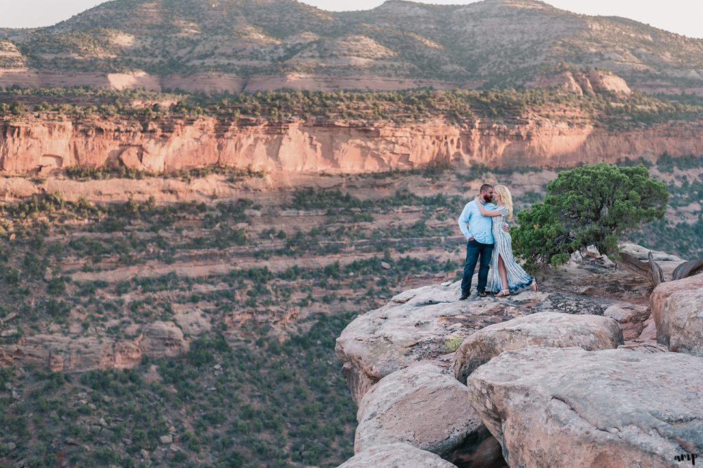 Far away photo of an engaged couple on the Monument