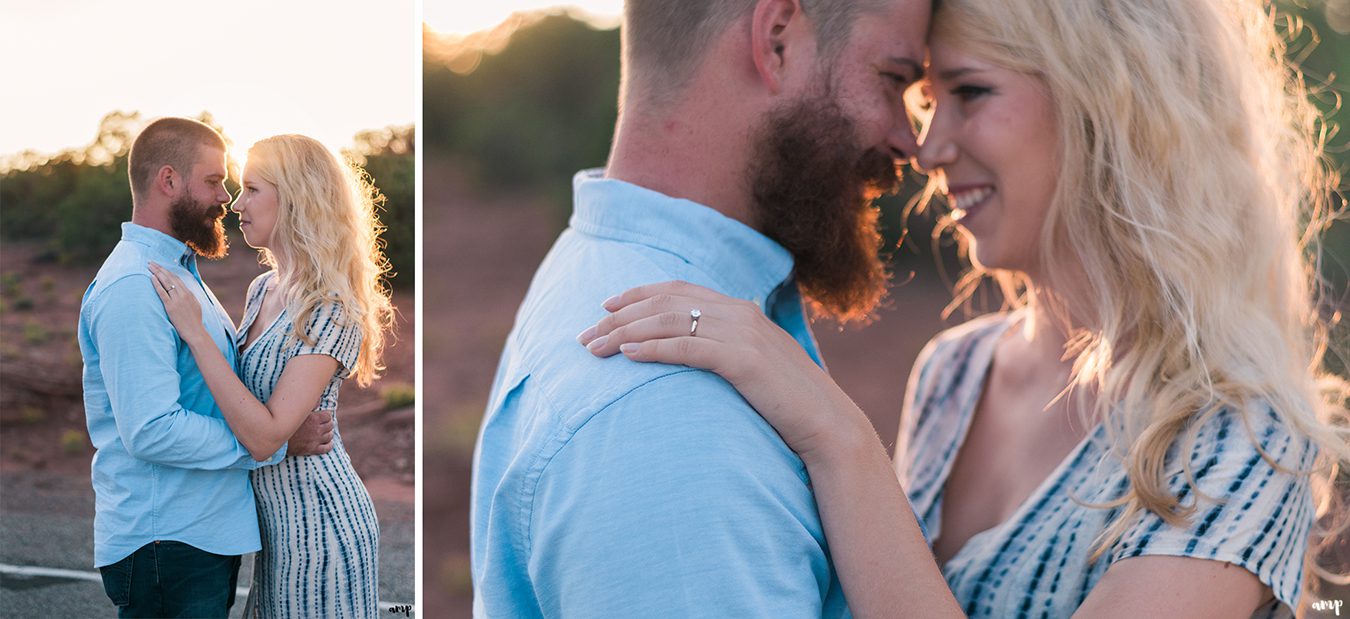 Engaged couple arm in arm as the sun sets behind them