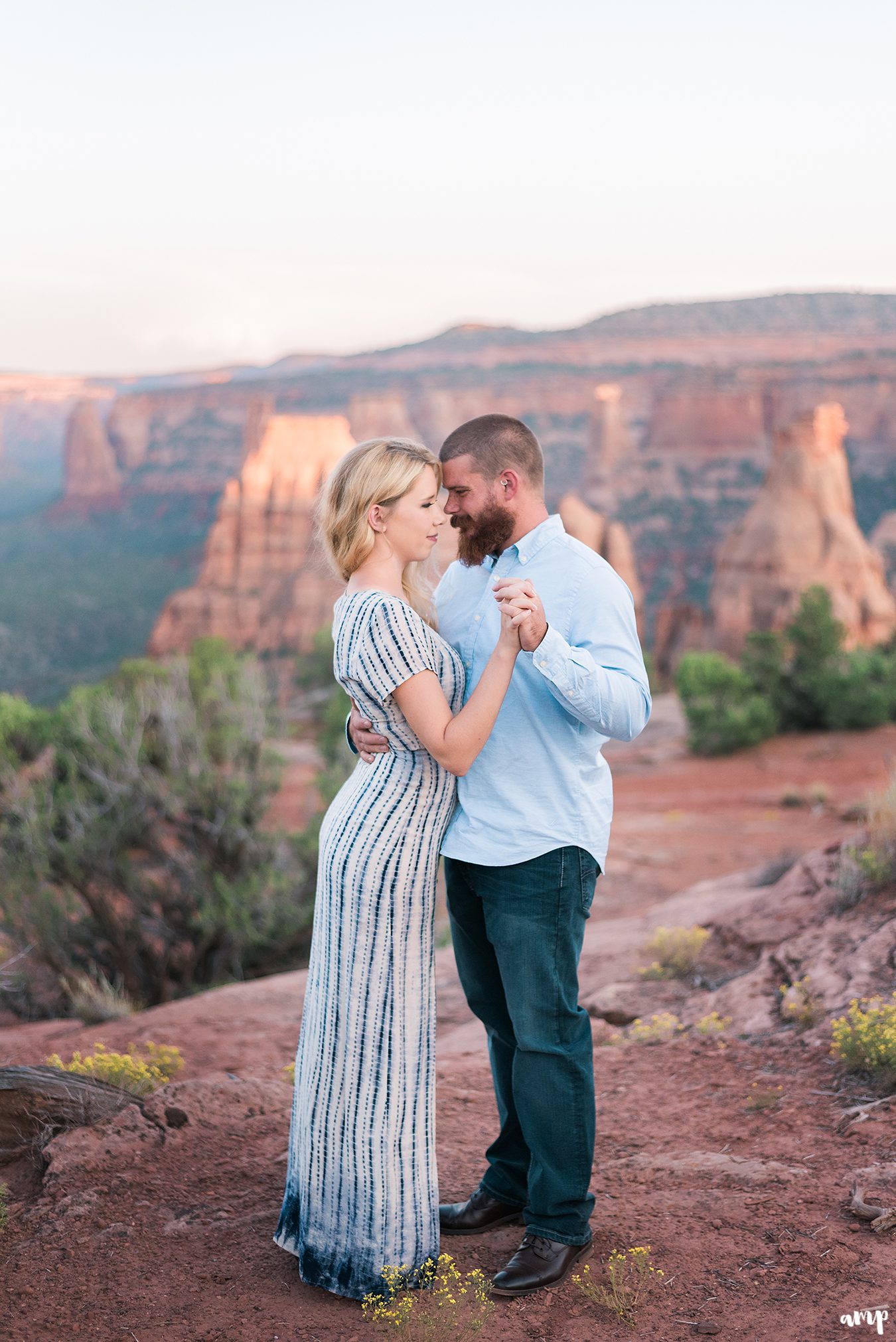 Engaged couple dances as the sun sets on the Colorado National Monument