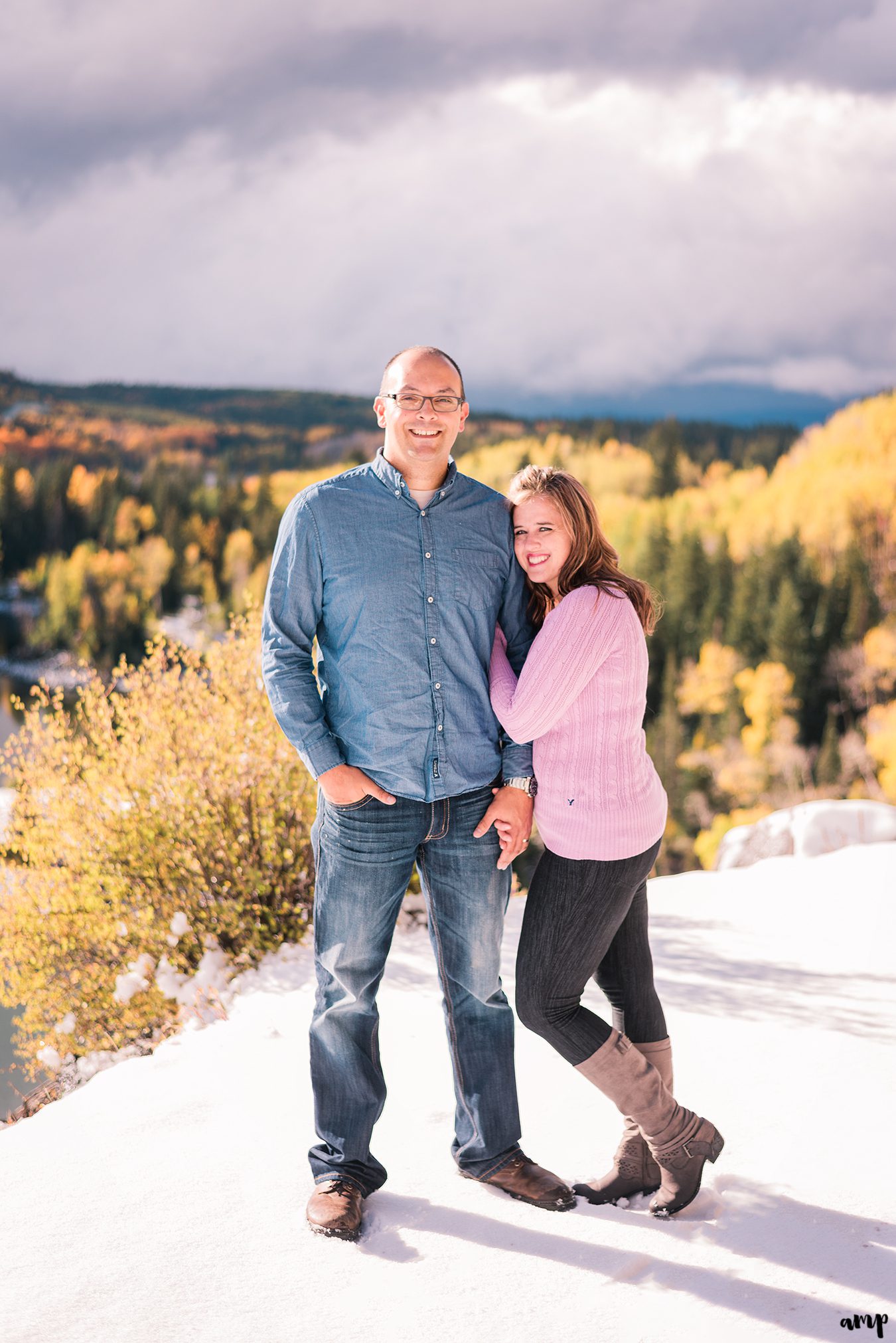 Couple snuggles among the fall yellow aspens of the Grand Mesa