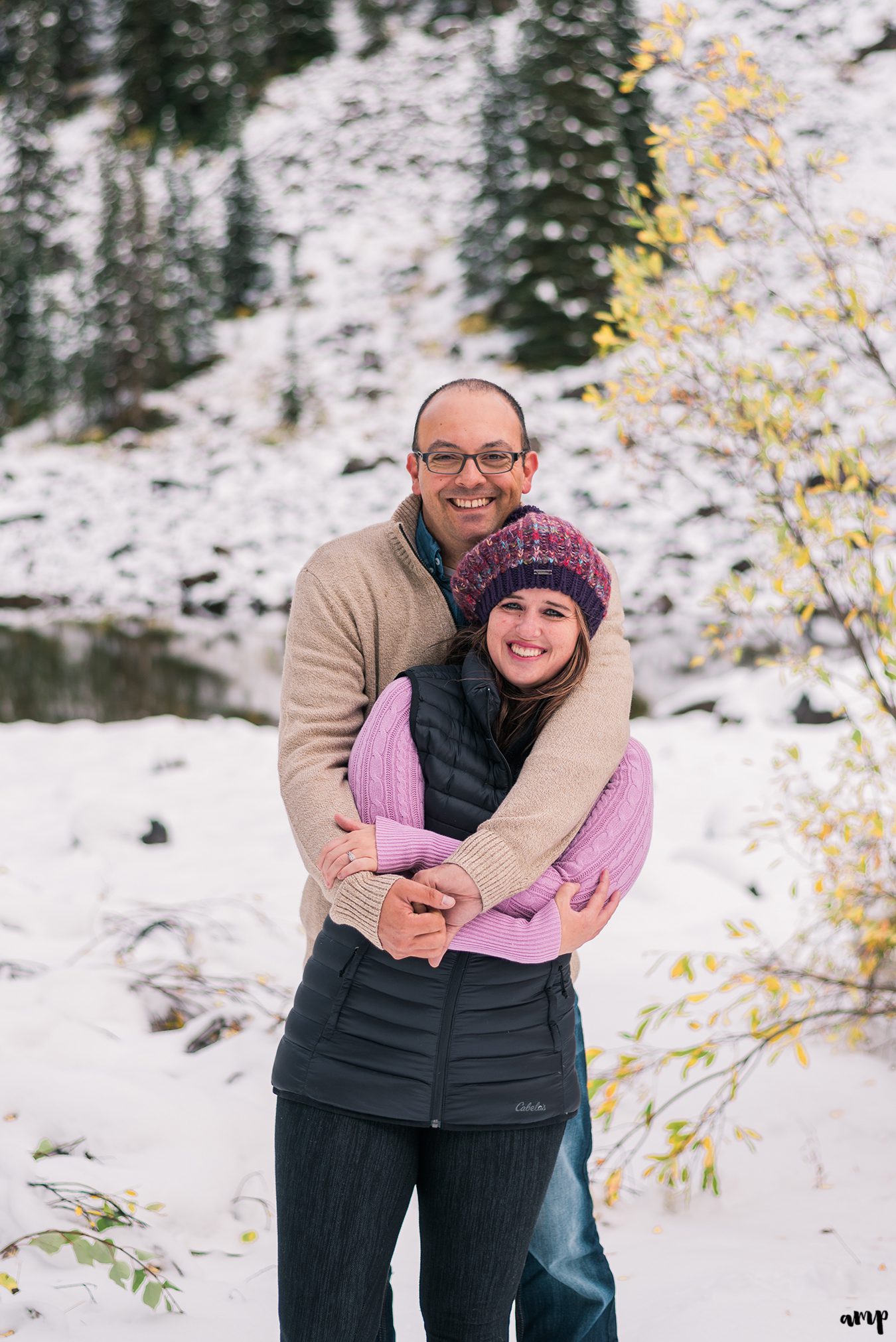 Couple snuggling in the snow on the Grand Mesa