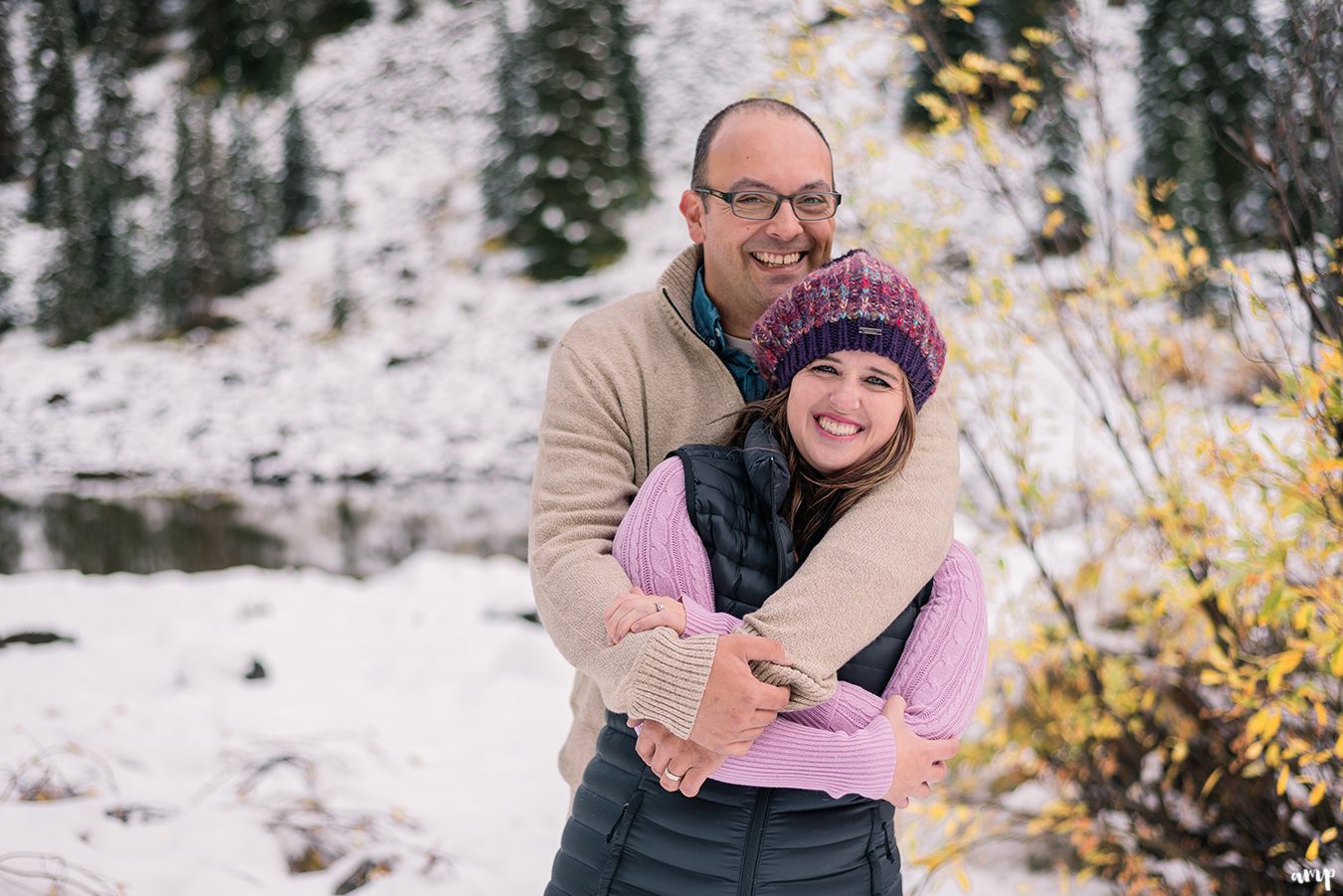 Couple snuggling in the snow on the Grand Mesa