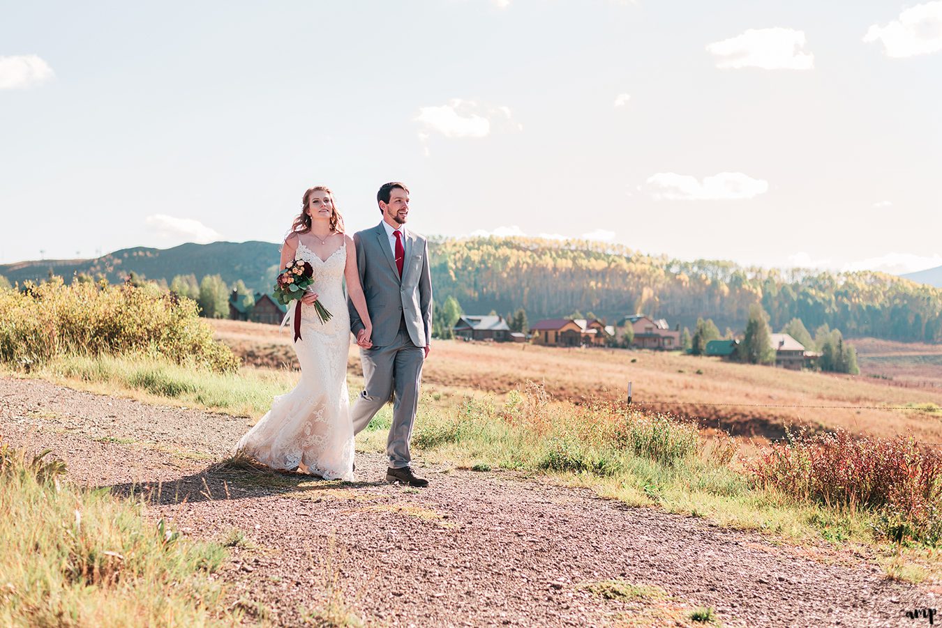 Bride and groom walk through the fall foliage at their Fall Wedding in Crested Butte at the Mountain Wedding Garden | amanda.matilda.photography