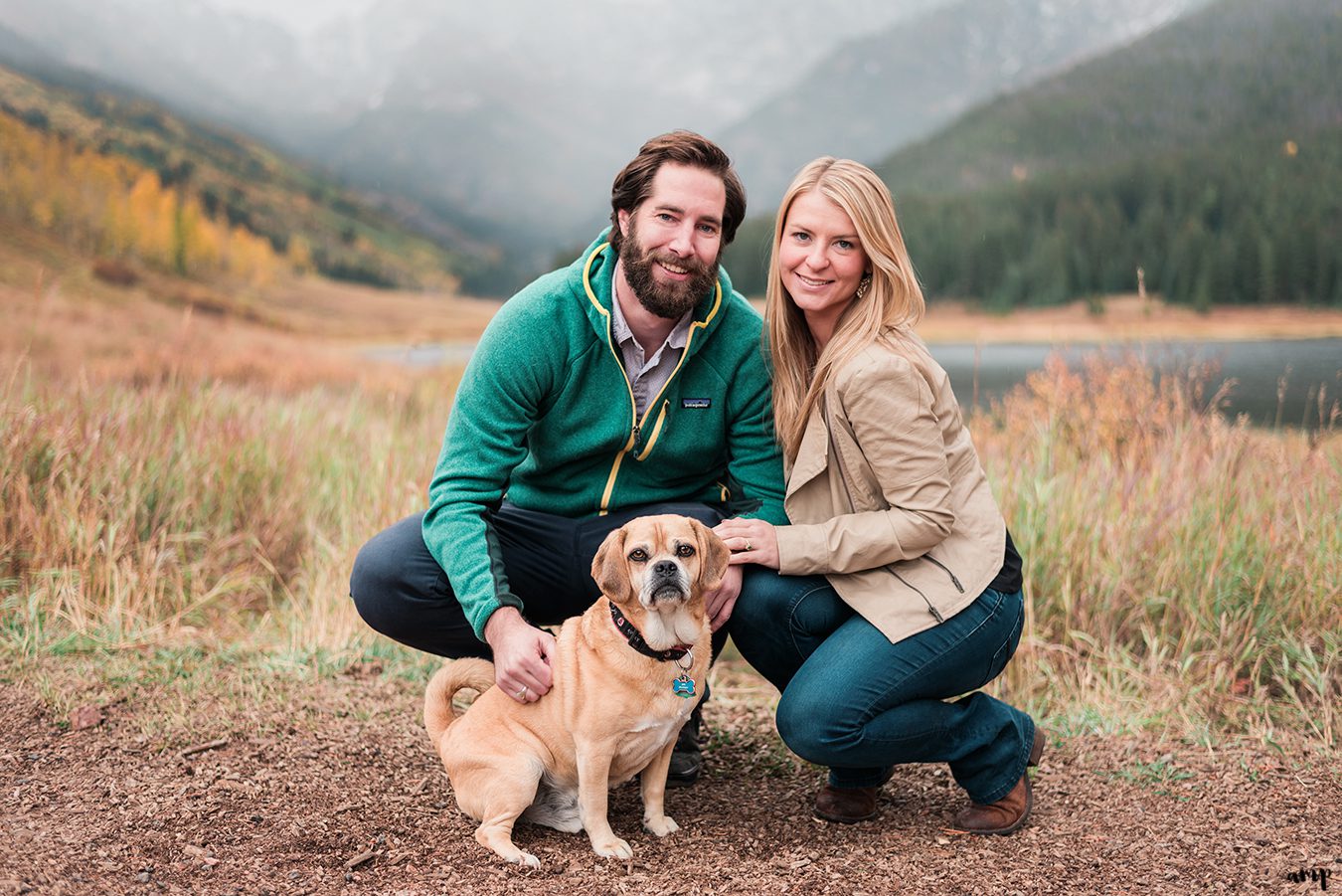 Engaged couple with their puggle dog at Piney River Ranch