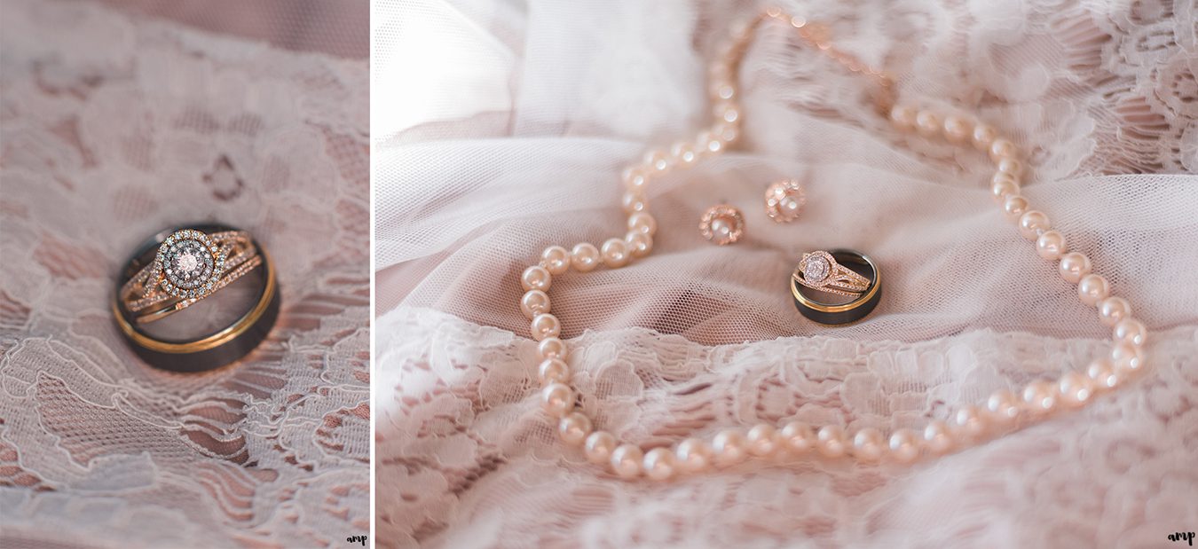 Gold wedding rings and pearls on a blush lace dress