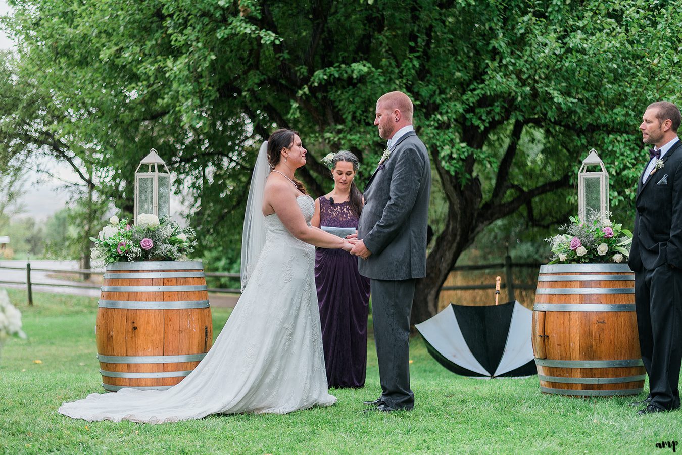 Bride and groom stand at the altar made of wine barrels