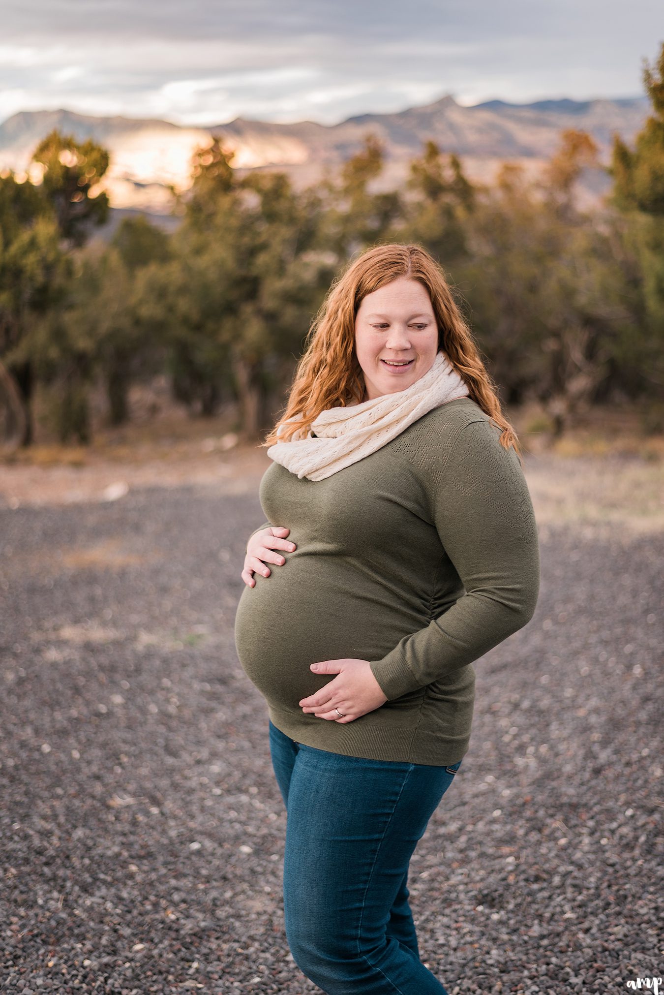 Pregnant woman with sunset mountains in the background