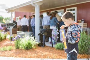 Kid blowing bubbles at a Palisade Wedding