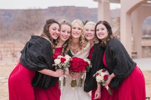 Bridesmaids pose with red roses for her Winter Wedding at Two Rivers Winery in Grand Junction | amanda.matilda.photography