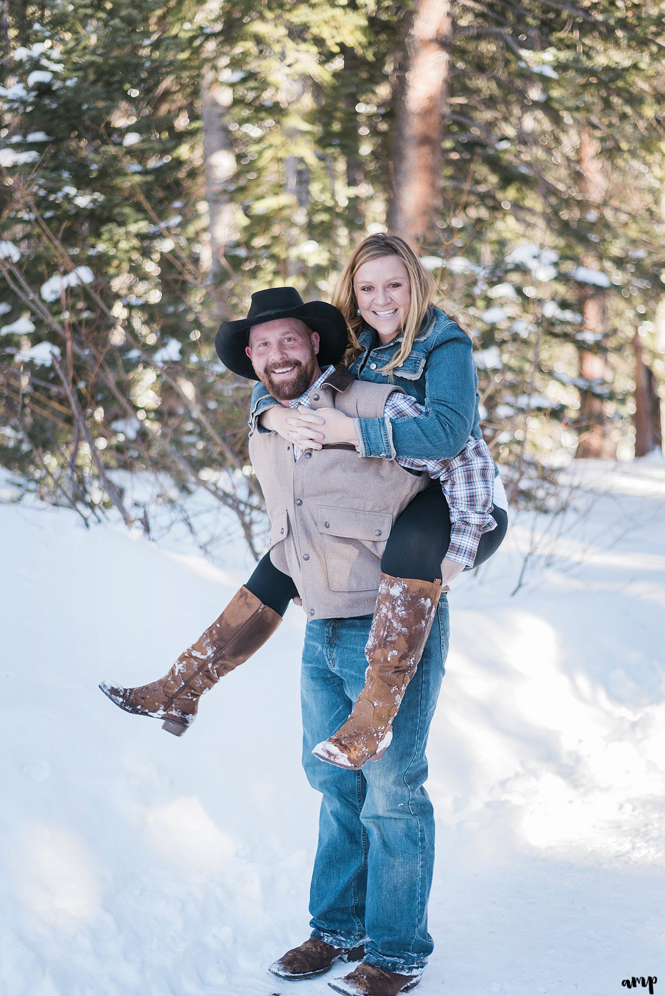 Engaged couple giving a piggy back ride on the grand mesa