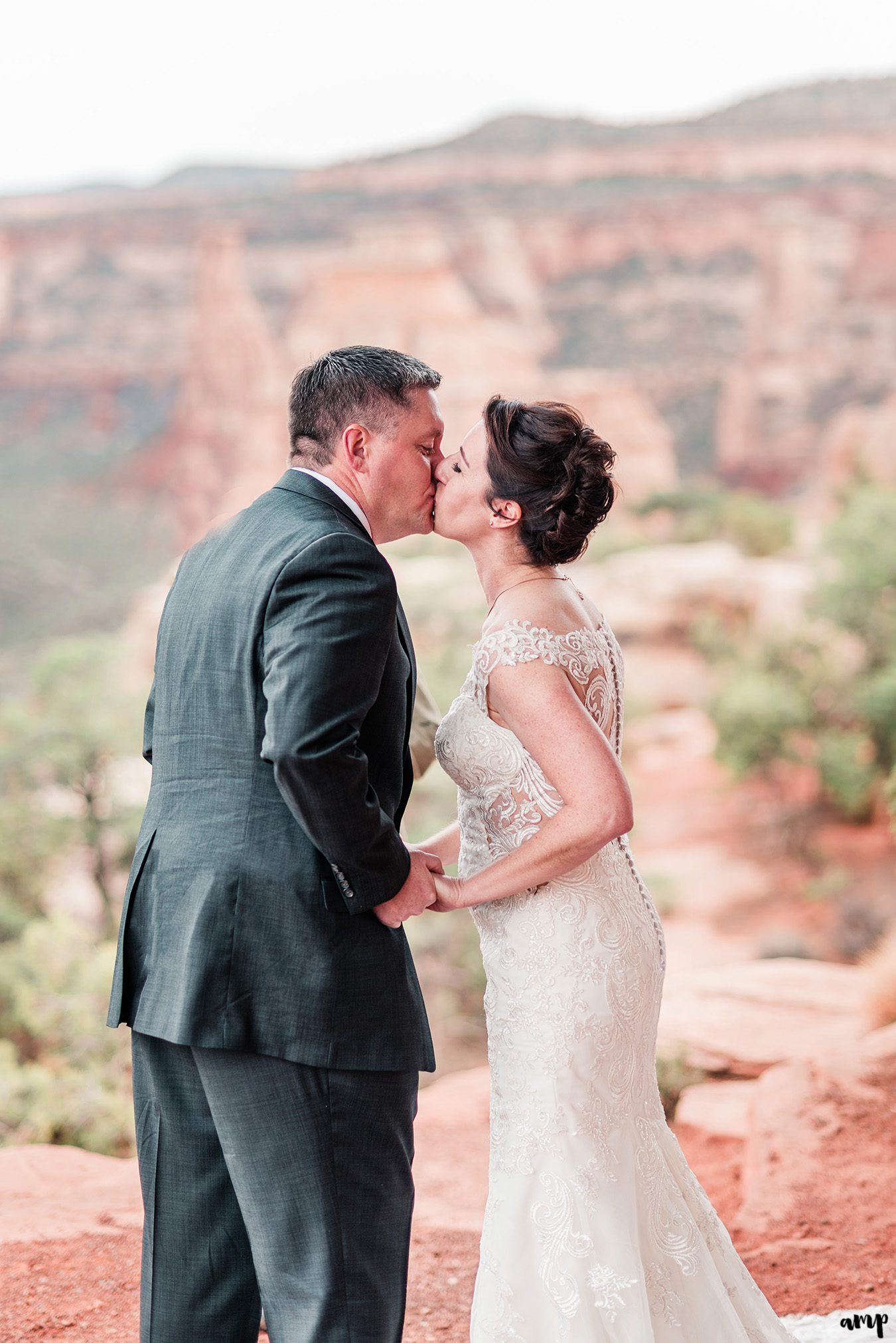 Newlyweds share their first kiss on the national monument in Grand Junction