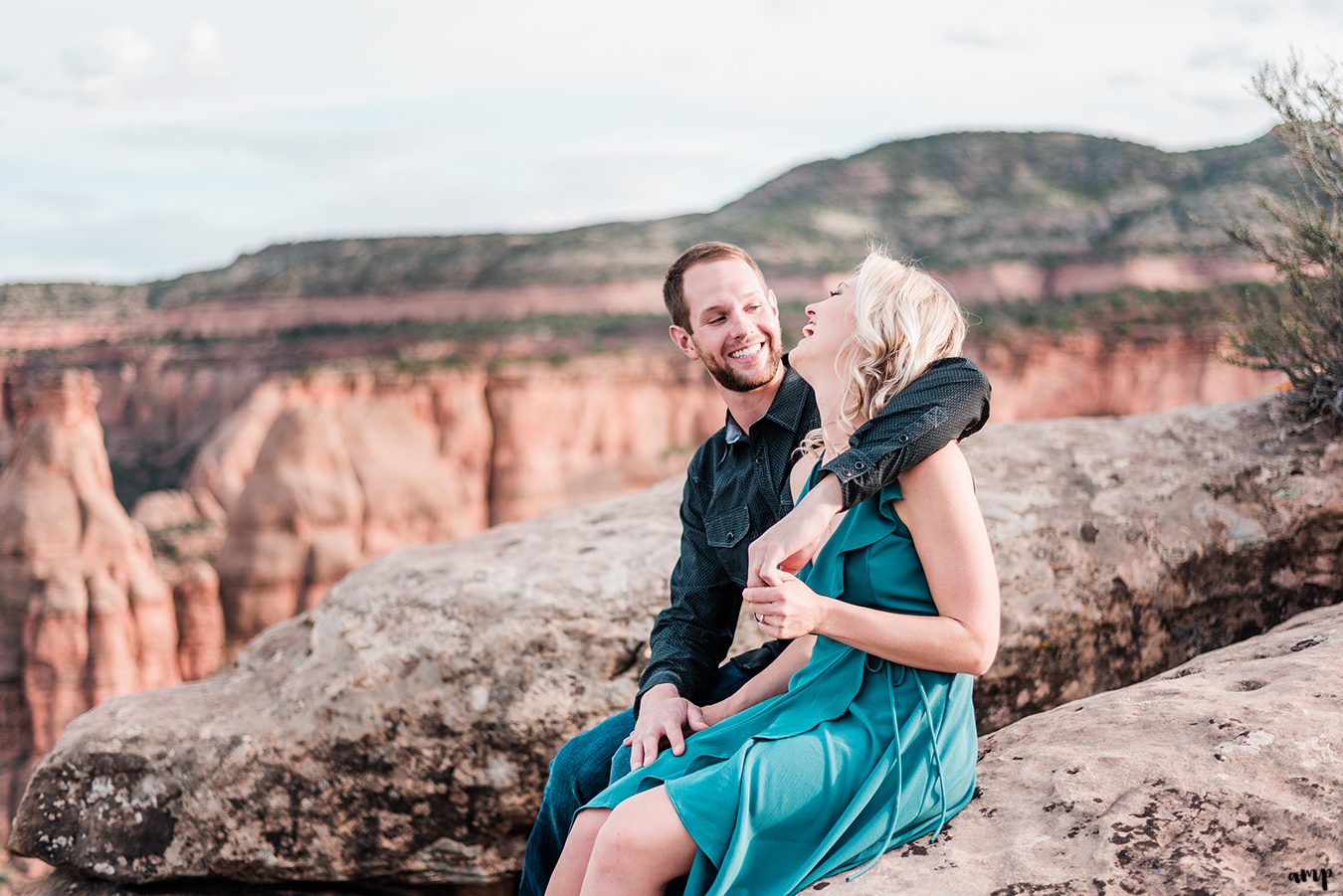 Dylan and Lexi laughing together atop the Colorado National Monument