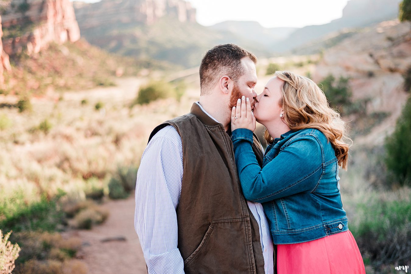 Ben and Dessa kissing in the Colorado National Monument for their engagement photos
