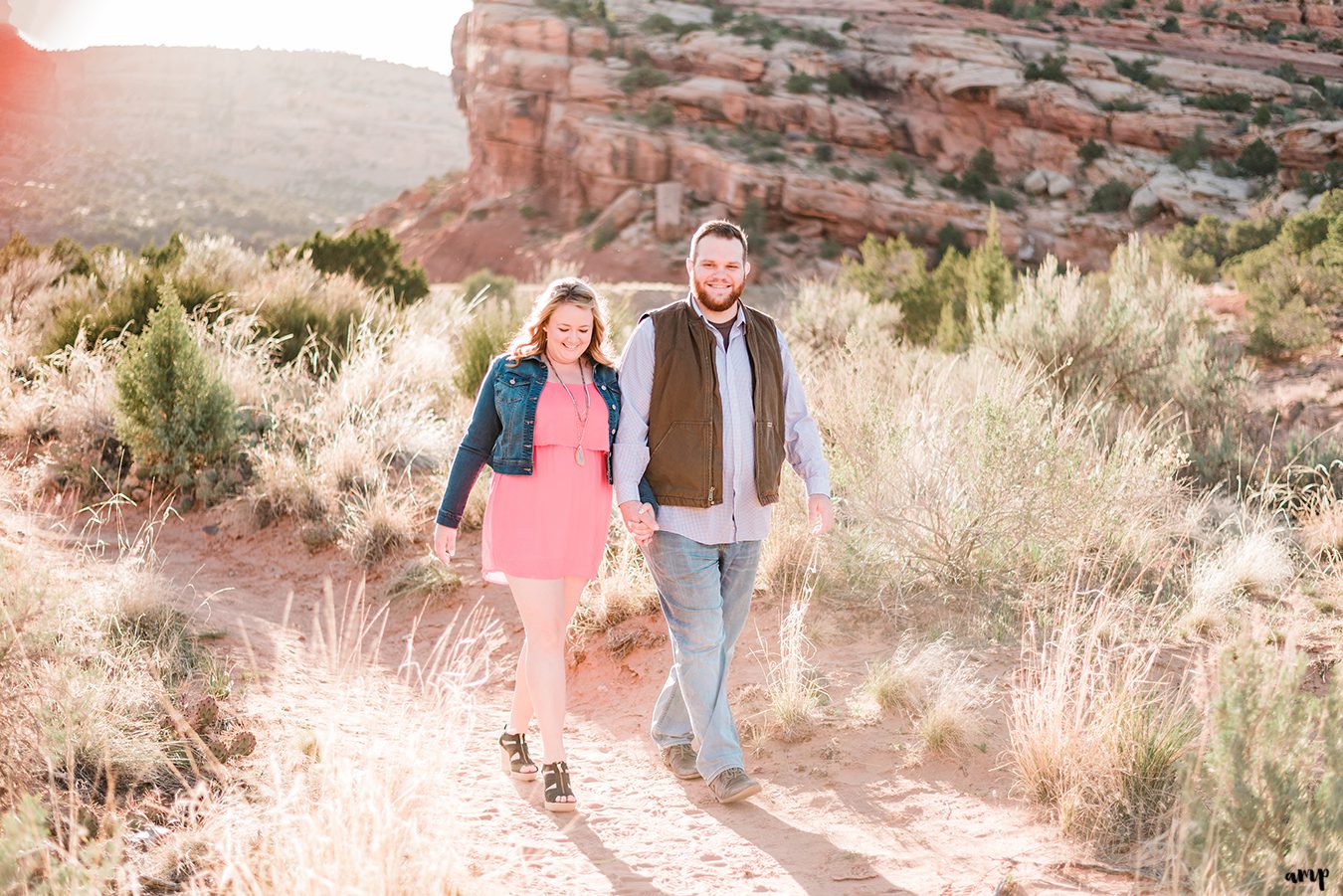 Dessa and Ben walking through the Colorado National Monument for their engagement photos