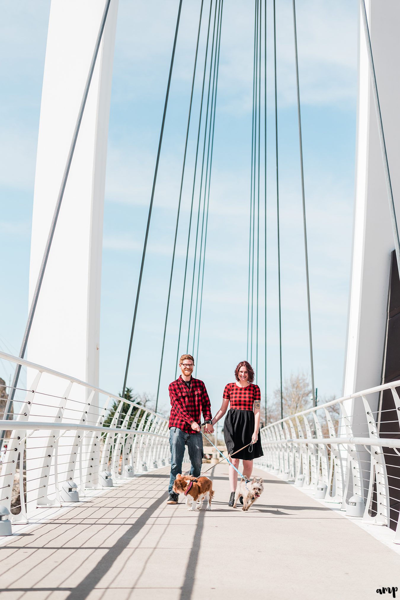 Ben and Courtnee walking their dogs along the Keeper of the Plains bridge