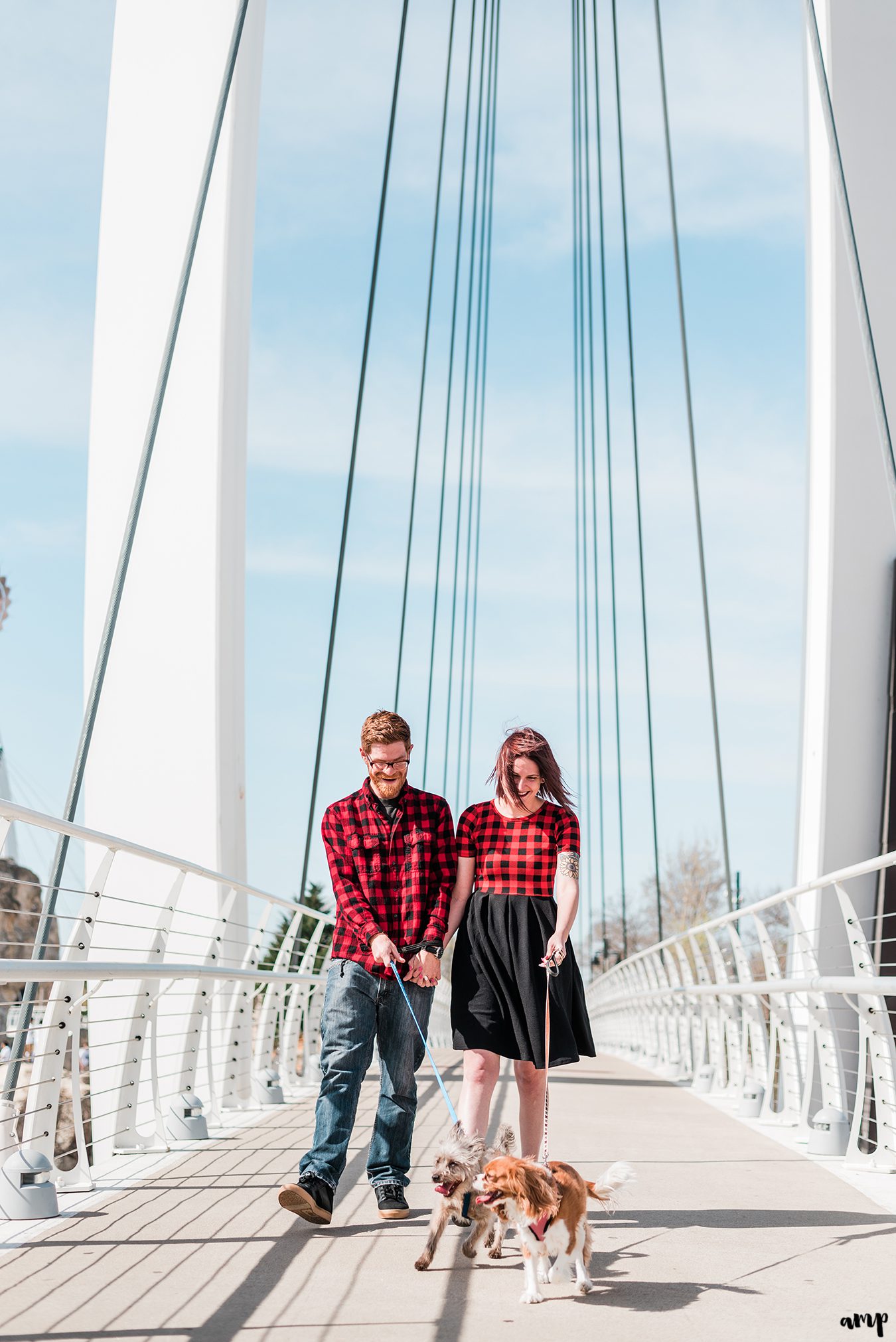 Ben and Courtnee walking their dogs along the Keeper of the Plains bridge